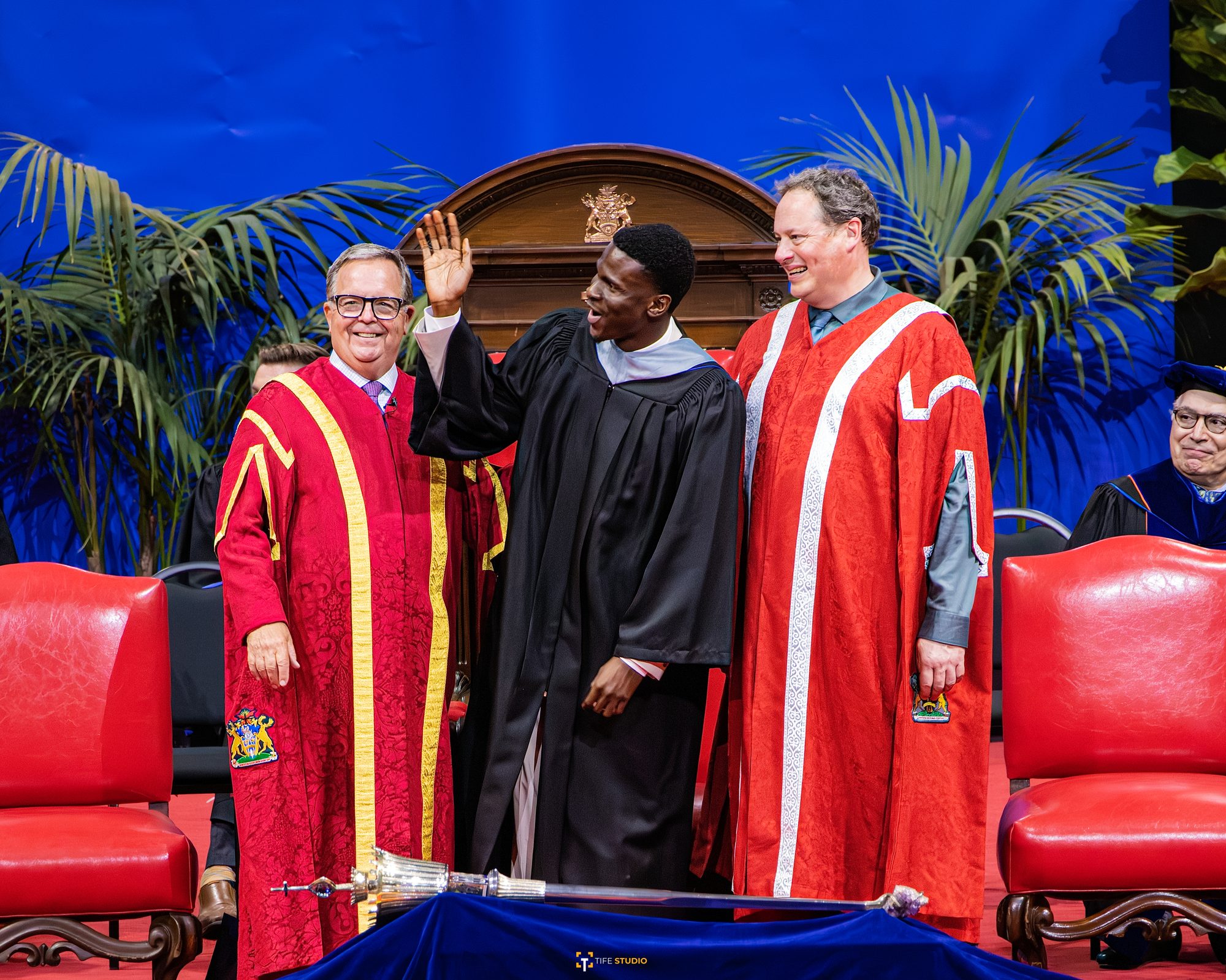 Graduate on stage with university officials